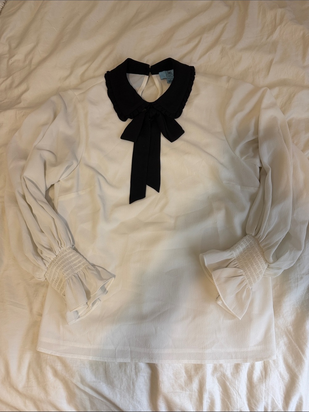 CeCe Ivory Blouse with Black Bow Collar
